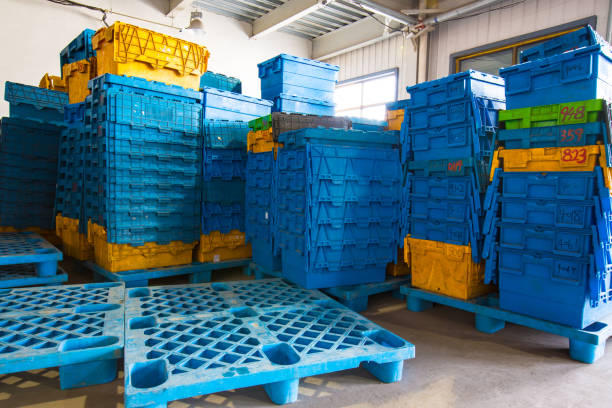 worker loading plastic crates in truck