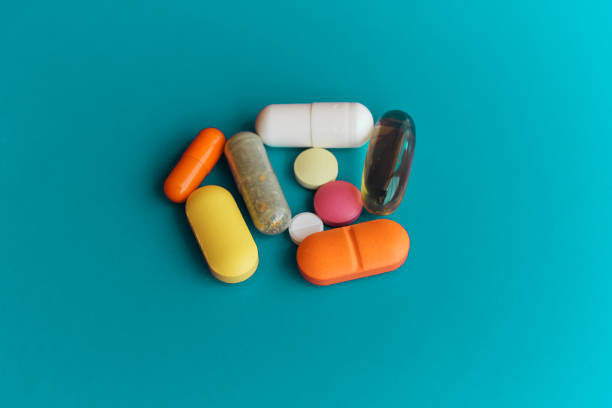 istock Pills close up on a blue background. 1401676616