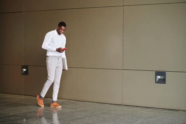 istock Black businessman browsing smartphone in office 1401676730