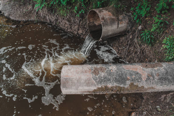 istock Sewage flows into the river. Pollution of the river. 1401676733