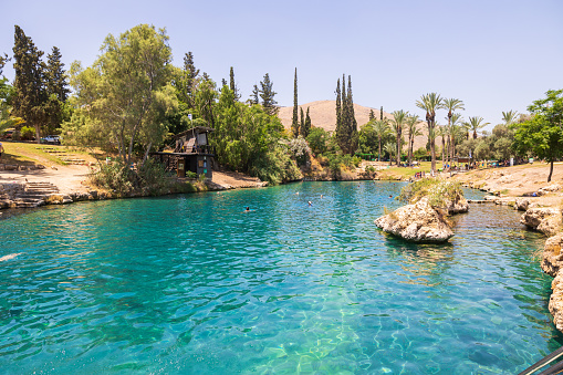 Gan HaShlosha, Israel -  Mai 24, 2022: People bathing in natural warm water pools in Gan HaShlosha National Park. The spring water maintains a constant, year-round temperature of 28 degrees Celsius.