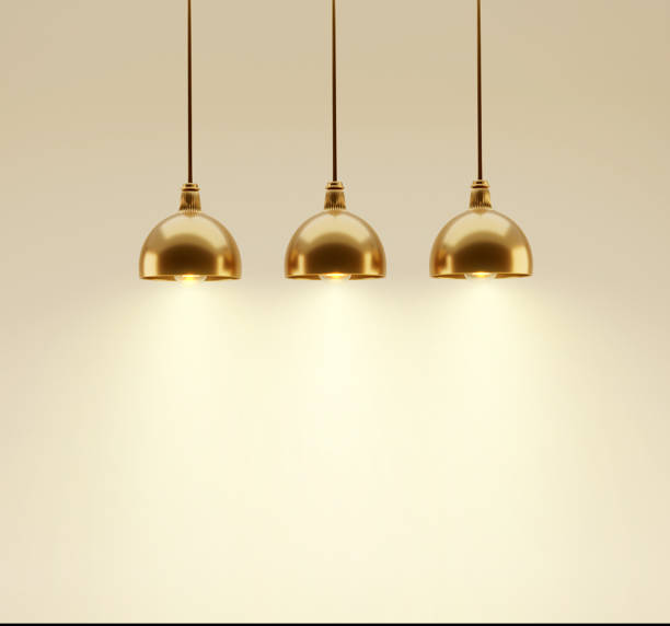 istock Three golden hanging ceiling lamps on beige background. Light sources, flood light on the empty wall.3d render image 1401677137