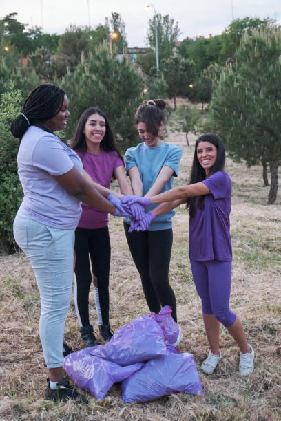 istock Group of multiracial active women putting their hands together after plogging. 1401678231
