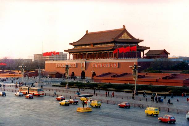 Dusk over Tiananmen Square in Beijing.Yellow minivans and taxis are characteristic of the era.Film photo in 1995,Beijing