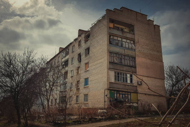 istock Destroyed residential building with broken windows and a hole in the wall after being shot. 1401681146