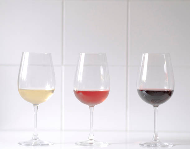 istock Red, white, and rose wine against a white background 1401681807