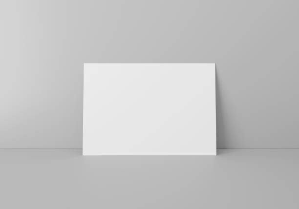 Empty white horizontal rectangle A4 paper sheet Empty white horizontal rectangle A4 paper sheet mockup on floor over grey wall, 3D rendering a4 paper stock pictures, royalty-free photos & images