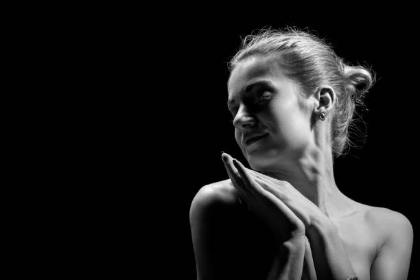 istock beautiful female profile with bare shoulders on black background with copy space, monochrome 1401685770