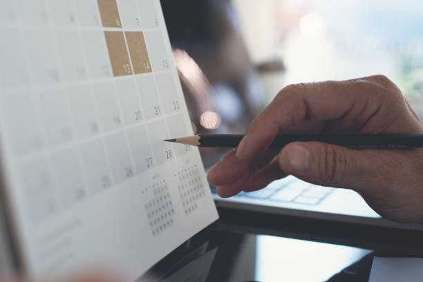 istock Business man planning his work schedule on calendar  event planner, timetable in office 1401687554