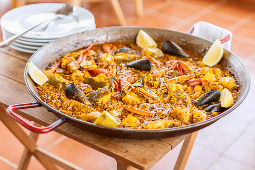 Traditional spanish seafood paella in the fry pan with mussels, langoustine and fish