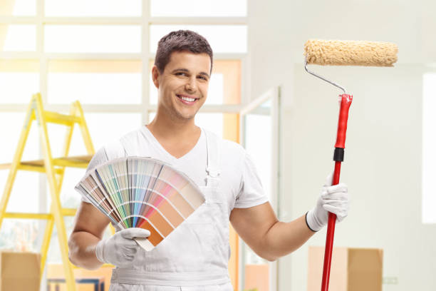 house painter with a paint roller - home decorator house painter color swatch paint imagens e fotografias de stock