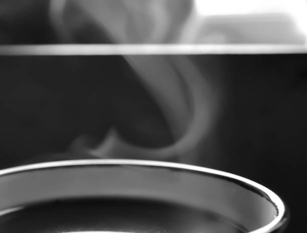 Soft steam comes out of the cup. Hot coffee with smoke. smoke from a cup. Hot drink - macro photography.