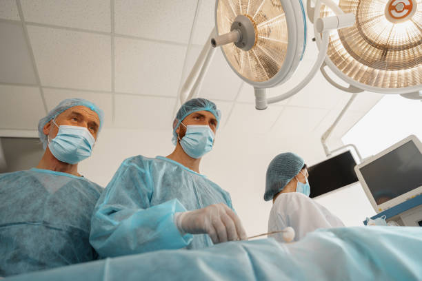 istock Concentrated surgical team working with a patient in an operation room 1401692956