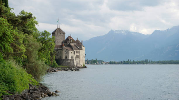 Canton Vaud, Switzerland - 23 MAY 2022 : Exterior of Chateau de Chillon, medieval castle and famous attraction on Lake Geneva, view from walking trail in Veytaux.