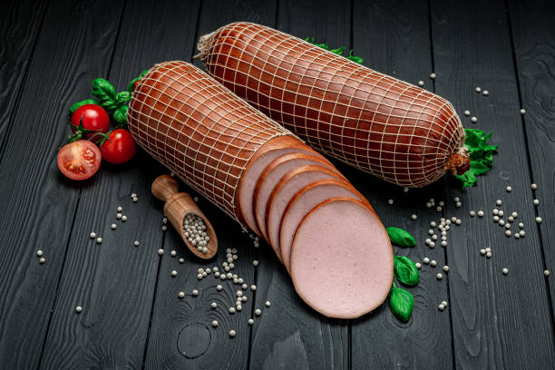 italian thick boiled sausage on a dark background. - bologna imagens e fotografias de stock