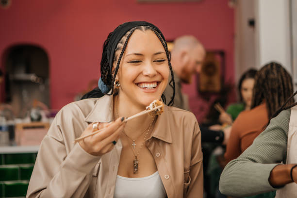 Beautiful woman enjoying Vegan Sushi in a local restaurant