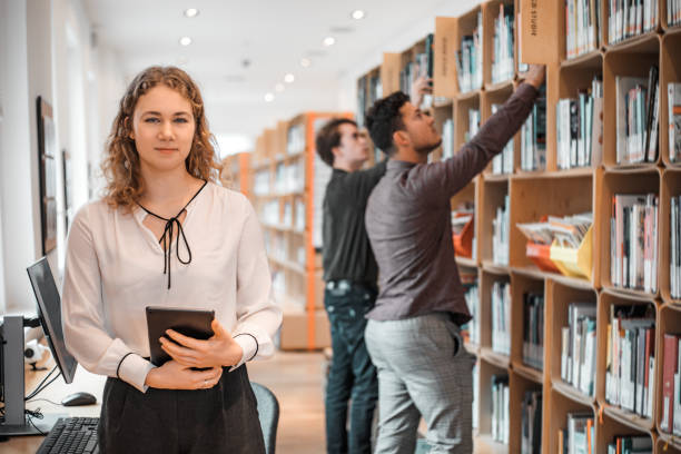 istock Beautiful female student studying in a public library 1401694654