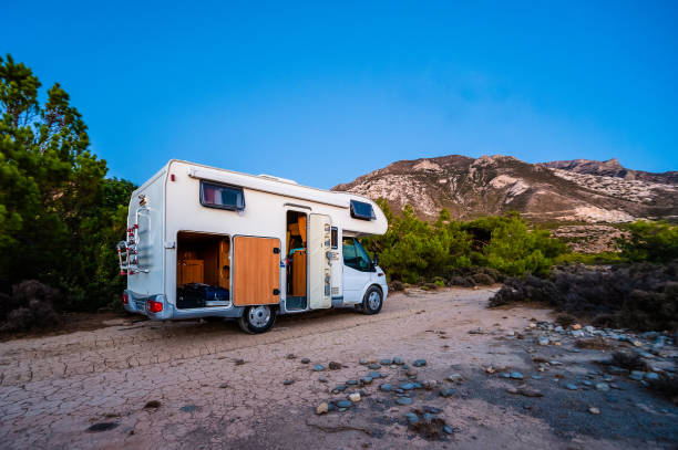 istock Motorhome RV parked on the beach under a tree next to main road, Crete, Greece. 1401696216