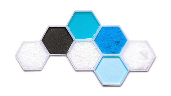 Chemical ingredient in hexagonal molecular shaped container. Polyethylene, Carbon Charcoal Powder, Shampoo Liquid, Urea, Copper (II) Sulfate, Hair Conditioner and Sodium Hydroxide Pellets.