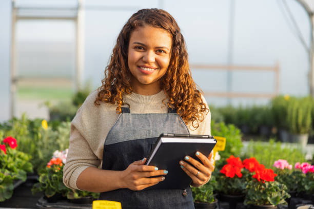 istock Female Environmentalist Using Digital Tablet In Greenhouse 1401699929
