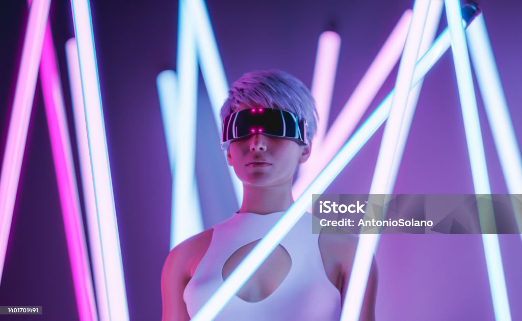 Futuristic woman in VR goggles in neon studio with illuminated sticks 3D rendering of stylish young female with short blond hair in futuristic VR glasses exploring virtual reality standing amidst illuminated neon sticks against purple background Futuristic Stock Photo