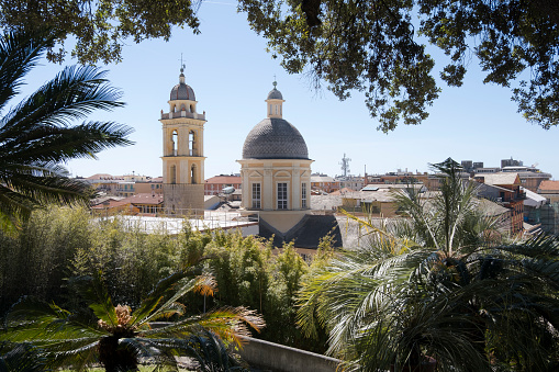 La Giralda Tower in Seville, famous landmark in Spain. Patio de Banderas with trees in the foreground.