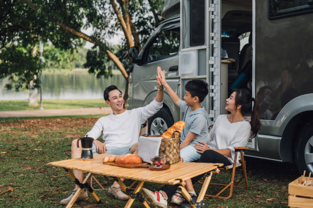 istock Happy Asian parents and their kid communicating while spending a spring day on camping 1401708844