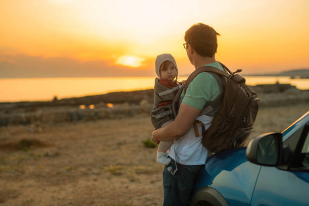 istock Father and daughter enjoying sunset on the beach 1401711543