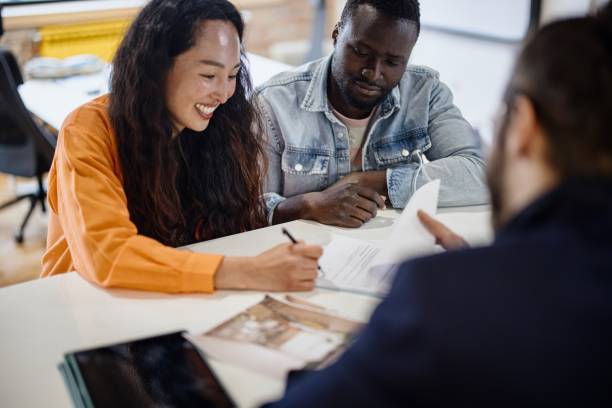 The couple signs the documents. Client consultation