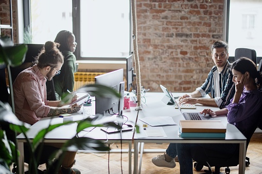 Multi-ethnic coworkers working on project