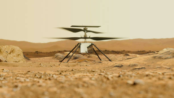 istock Helicopter Ingenuity explore Mars. Drone on the ground of Mars examining rocks 1401713218