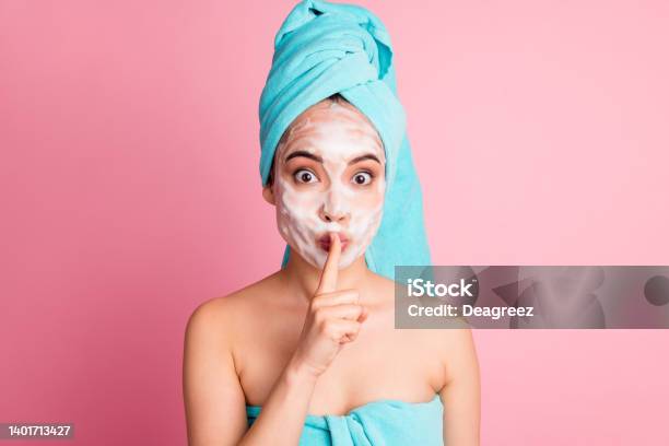 Photo Of Charming Pretty Young Woman Cover Finger Lips Wear Blue Turban Towel Isolated On Pastel Pink Color Background Stock Photo - Download Image Now