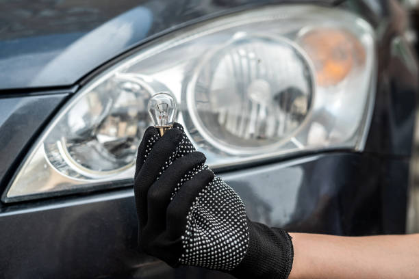istock mechanic changing light bulb in his car 1401713604