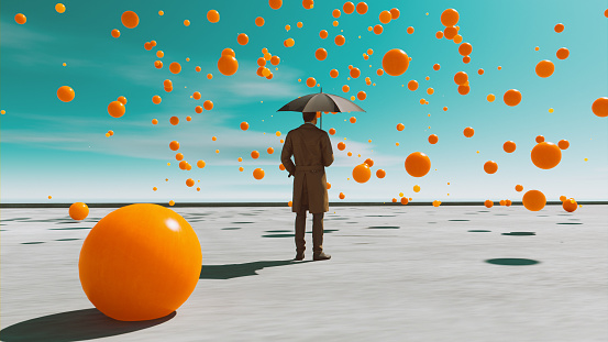 Man wears trench coat and holds an umbrella while standing outside on a day with clear sky. But it still rains from the sky with orange balls in different sizes. Concept image of brain storming, having mental illness or a wild imagination.