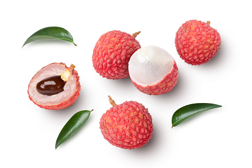 Lychee with leaves on white background. Top view.