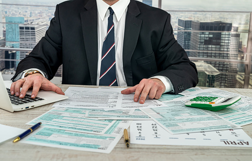 businessman working with documents 1040 tax form in office. Concept of accounting financial annual report