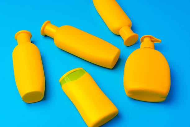 istock Bottles of sunscreen cream on blue background 1401722117