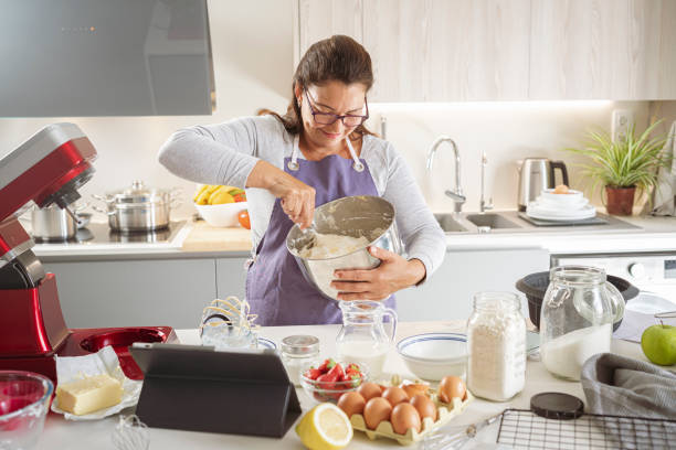 istock Woman making cream for cake at home 1401722126