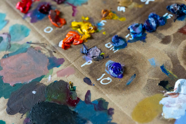 An impromptu cardboard artists pallete.  It has acrylic and oil paints of various colours on the palette.
