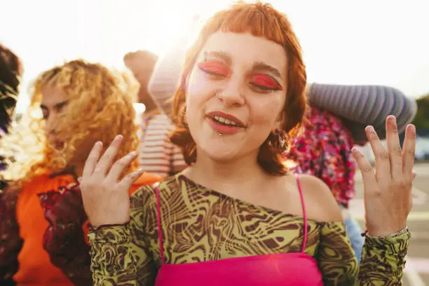 Photo of Young diverse people having fun outdoor laughing together - Soft focus on girl nose