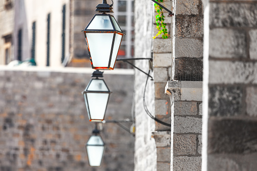 Vintage street lamp on the wall side . Lanterns and bick wall