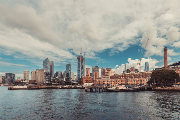 Sydney City, Australia - April 16, 2022: Sydney central business district and Circular Quay viewed through Campbells Cove from Hickson Road Reserve on a day