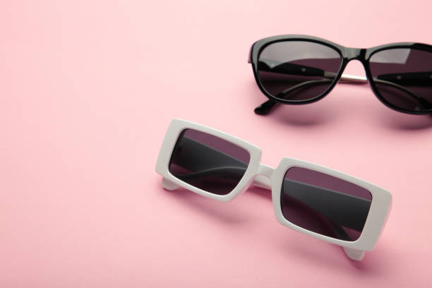 istock White and black sunglasses on pink background, top view, flat lay, minimalistic concept of summer, vacation 1401726169