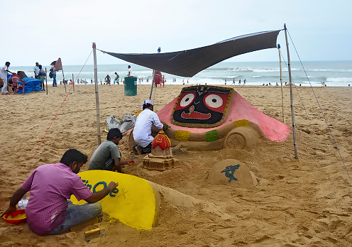 Puri sea beach is very famous for sand sculpture, few sand sculpture artists are making a sand sculpture of Lord Jagannatha on Puri sea beach before the famous Chariot festival of Puri, Odisha.