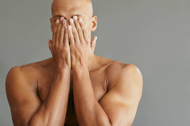 istock Unrecognizable black man covering his face with hands. 1401728967