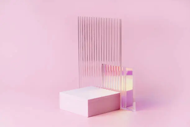 Photo of Empty podium for product display. Monochrome Pedestal with ribbed  glass on pink background. Stylish background for presentation. Minimal style.