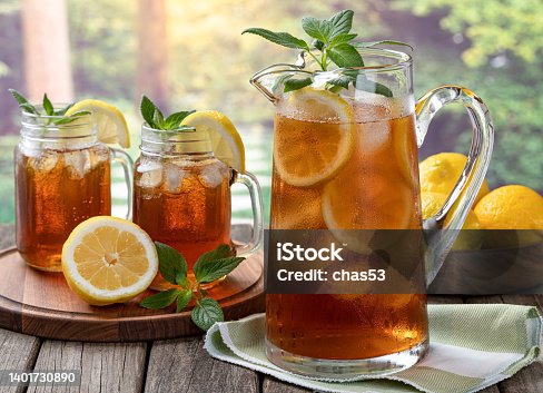 istock Pitcher of cold ice tea with rural summer background 1401730890
