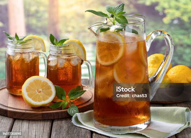 Pitcher Of Cold Ice Tea With Rural Summer Background Stock Photo - Download Image Now
