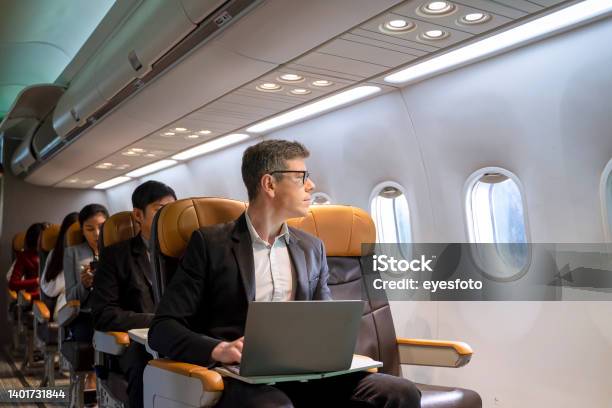 Passengers Are Sitting In The Commercial Plane Stock Photo - Download Image Now - Airplane, Business Travel, Travel
