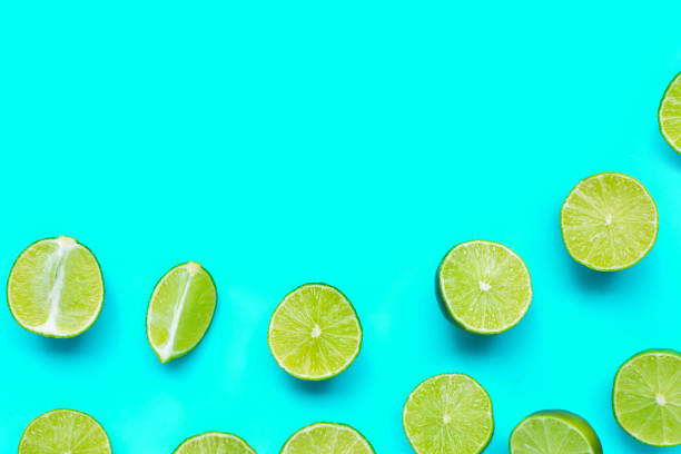 istock Fresh limes on blue background. top view 1401735476